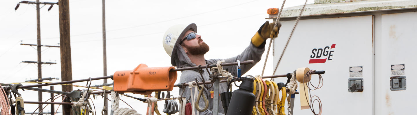 Technician working on an electrical pole