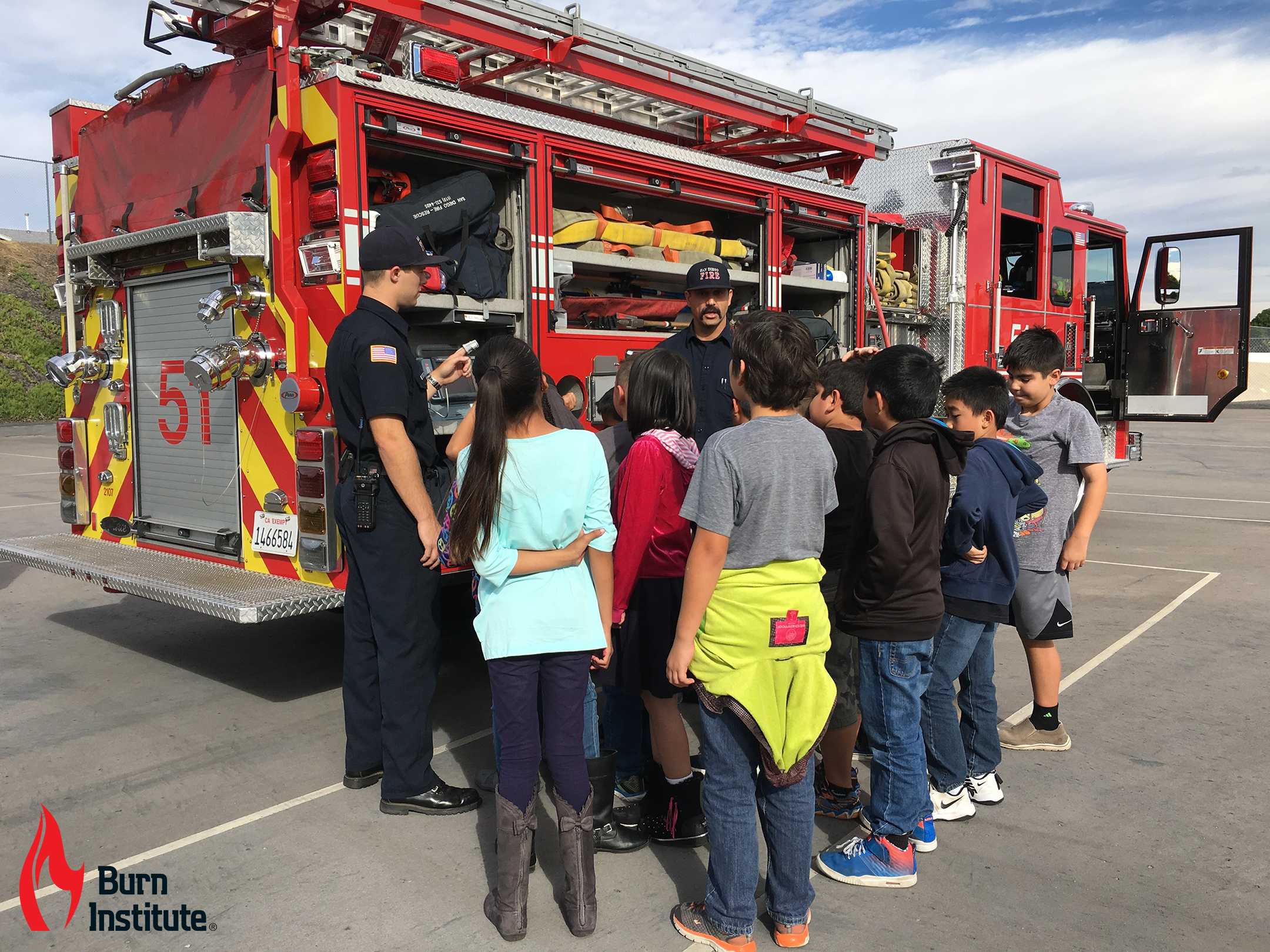 Children gathered around a fire truck