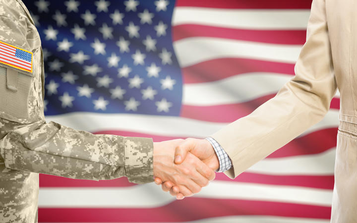 Miltary handshake over a flag