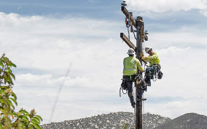 line workers on electric pole
